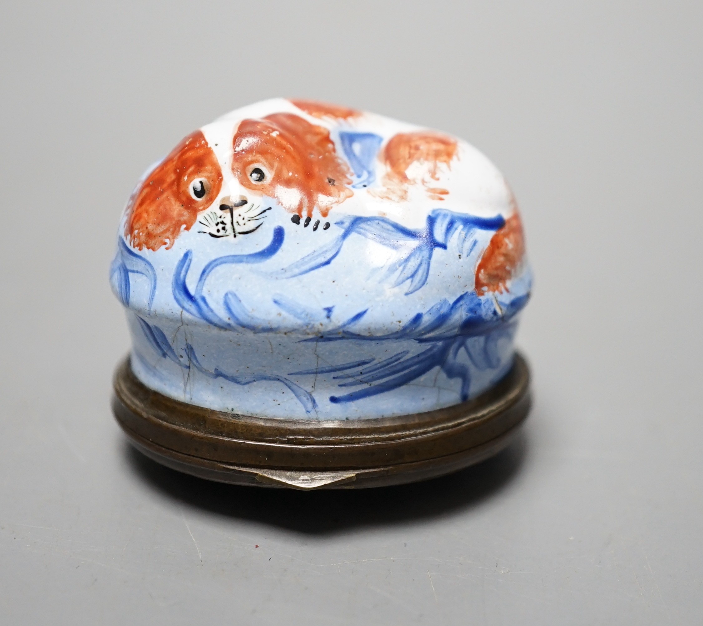 A Late 18th century South Staffordshire enamel patch box, 3.9cm, modelled as a spaniel recumbent on a cushion, the cover inscribed present from a friend